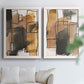 Set of two white barnwood framed canvas prints depicting tan brown gray and cream shapes with loose rectangular structure arranged across two complementary compositions above a sofa in a bright living space.