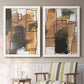 Set of two white barnwood framed canvas prints depicting two retro geometric abstracts featuring earthy watercolor blocks crossed by black contour lines above a sideboard in a cozy sitting room.
