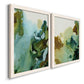 Angled view of a set of two white barnwood framed canvas prints featuring two organic watercolor abstracts featuring fluid green blue and earthy brown ink pools.