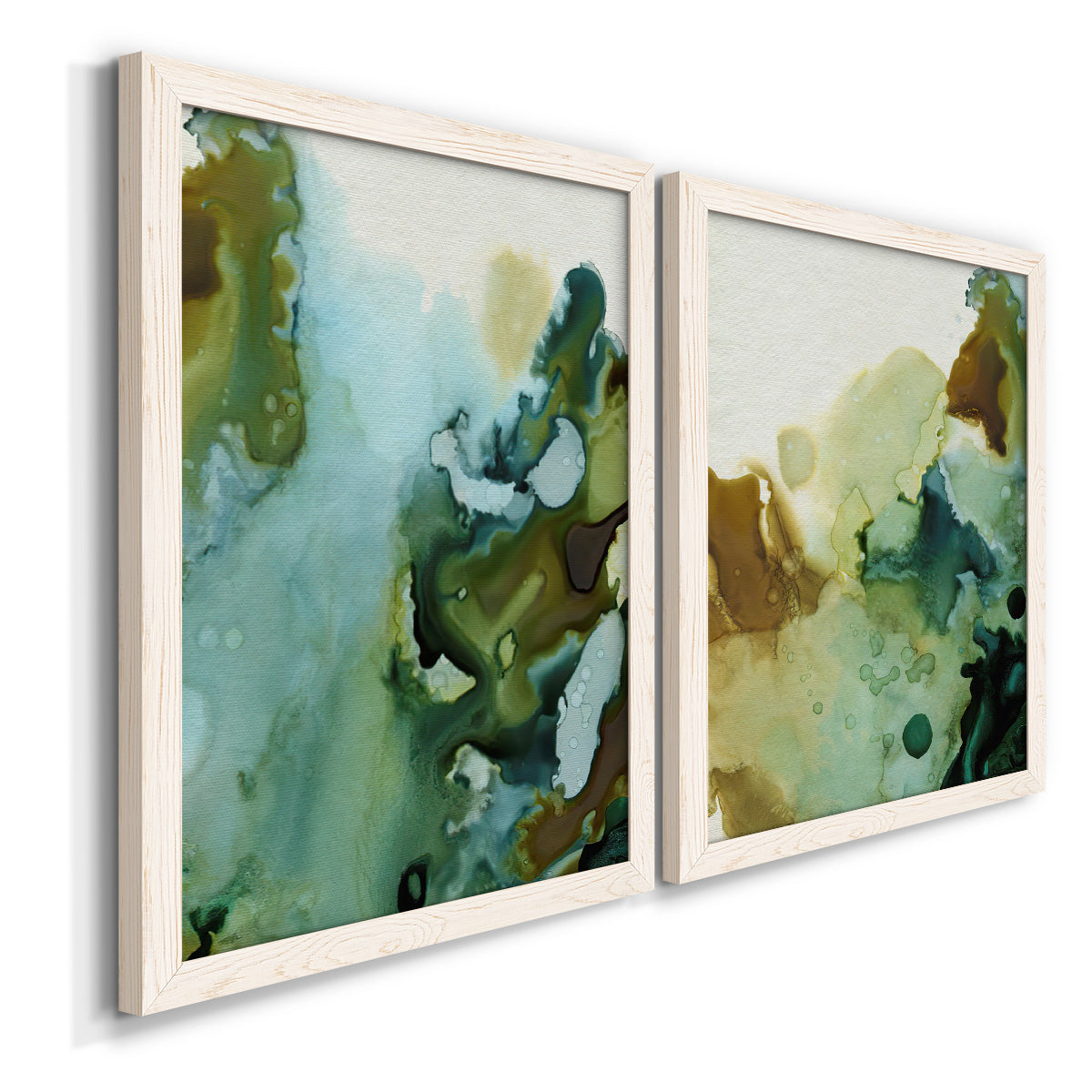 Angled view of a set of two white barnwood framed canvas prints featuring two organic watercolor abstracts featuring fluid green blue and earthy brown ink pools.
