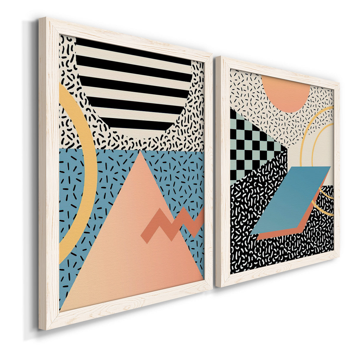 Angled view of a set of two white barnwood framed canvas prints featuring two retro graphic abstracts featuring bold geometric Memphis-style patterns.