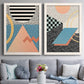 Set of two white barnwood framed canvas prints depicting paired retro graphic abstracts with checkerboards stripes squiggles peach blue black and mint shapes above a sofa in a contemporary living room.
