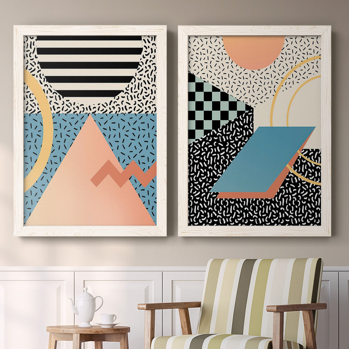 Set of two white barnwood framed canvas prints depicting two retro graphic abstracts featuring bold geometric Memphis-style patterns above a sideboard in a cozy sitting room.