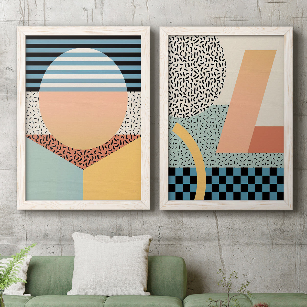 Set of two white barnwood framed canvas prints depicting a coordinated art pair of bold geometric Memphis-style patterns rendered as retro graphic abstracts above a sofa in a modern living room.