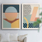 Set of two white barnwood framed canvas prints depicting checkerboards stripes squiggles peach blue black and mint shapes arranged across two complementary compositions above a sofa in a bright living space.