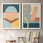 Set of two white barnwood framed canvas prints depicting two retro graphic abstracts featuring bold geometric Memphis-style patterns above a sideboard in a cozy sitting room.