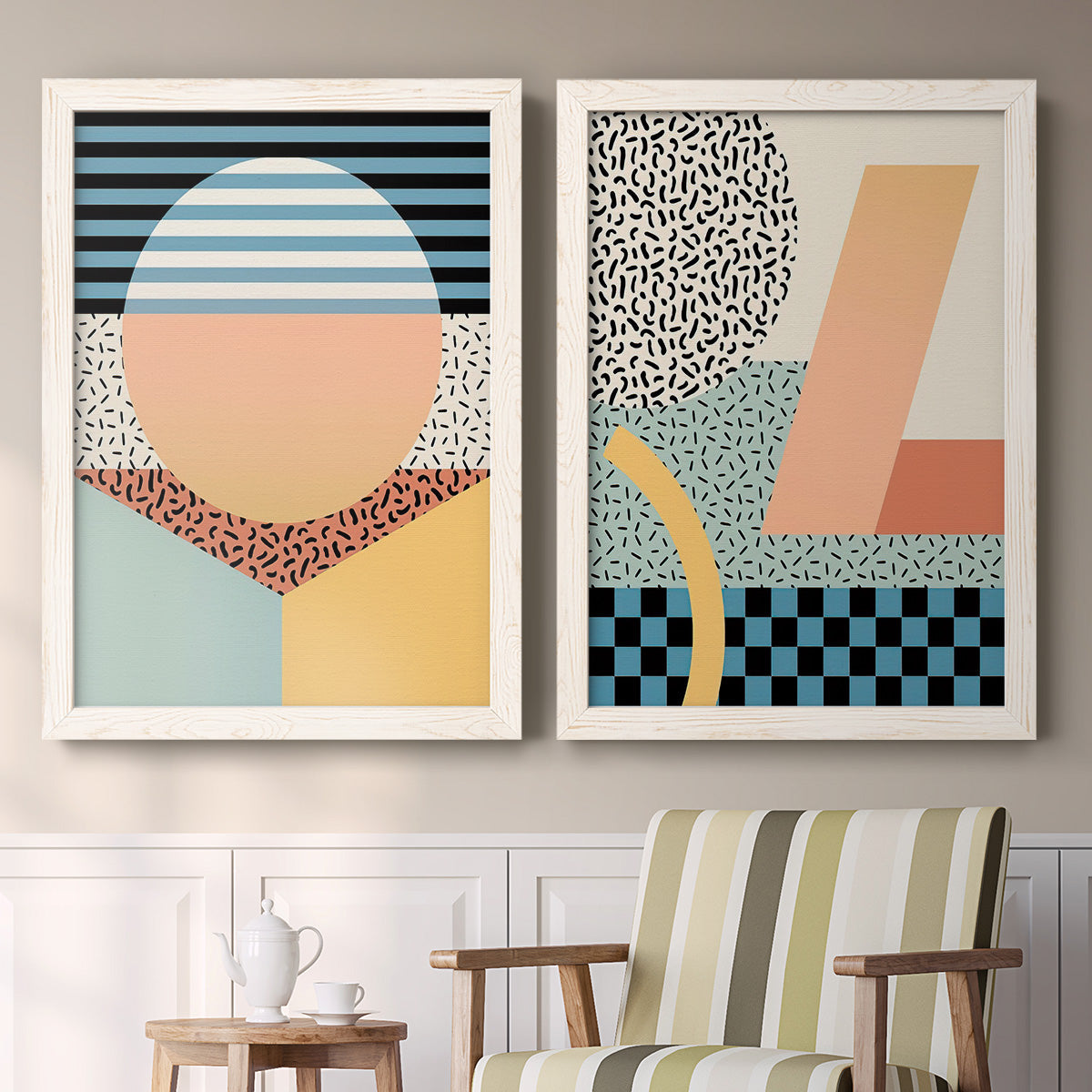 Set of two white barnwood framed canvas prints depicting two retro graphic abstracts featuring bold geometric Memphis-style patterns above a sideboard in a cozy sitting room.