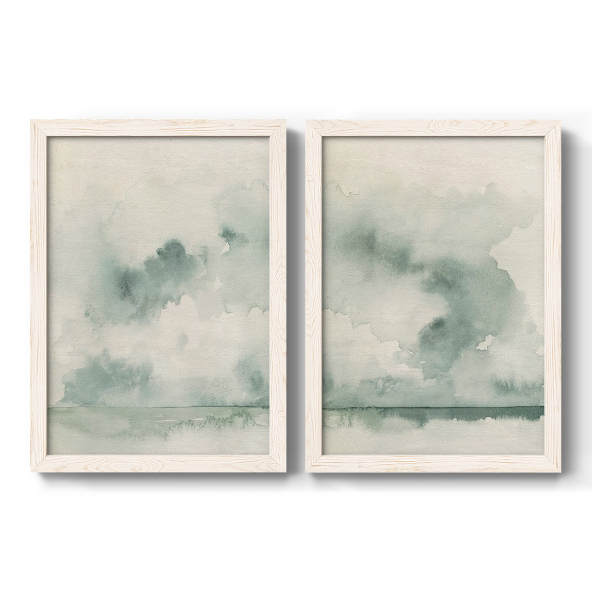 Set of two white barnwood framed canvas prints featuring two minimalist watercolor seascapes with misty green clouds calm horizons and pale reflective water.