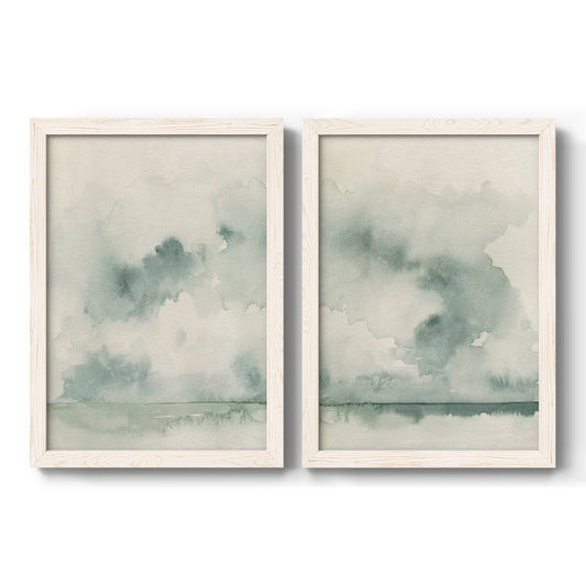 Set of two white barnwood framed canvas prints featuring two minimalist watercolor seascapes with misty green clouds calm horizons and pale reflective water.