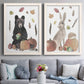 Set of two white barnwood framed canvas prints depicting playful watercolor wildlife surrounded by pumpkins acorns apples feathers and muted fall colors above a sofa in a contemporary living room.