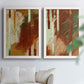 Set of two white barnwood framed canvas prints depicting vertical stripes, scraped paint, and weathered layered texture arranged across two complementary compositions above a sofa in a bright living space.