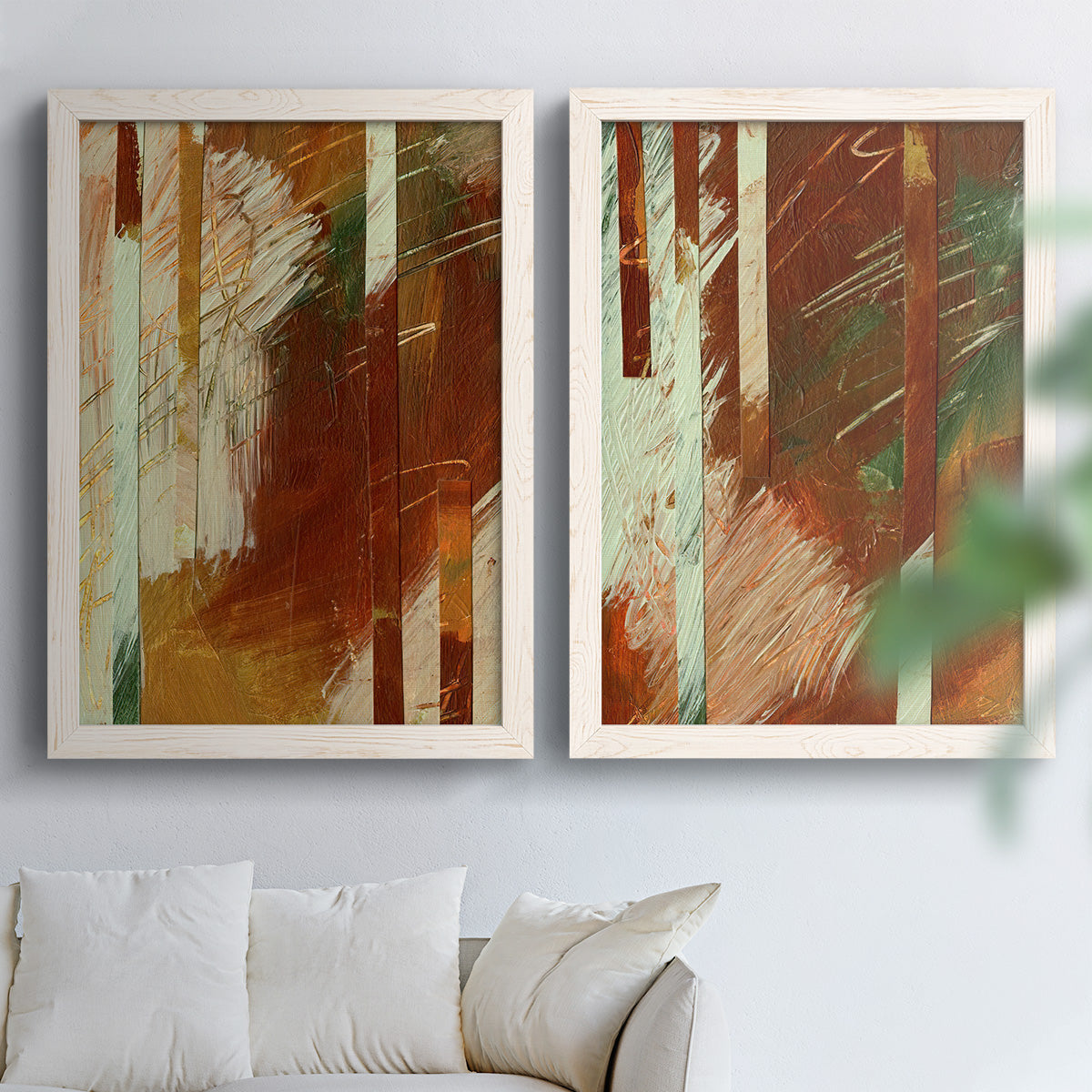 Set of two white barnwood framed canvas prints depicting vertical stripes, scraped paint, and weathered layered texture arranged across two complementary compositions above a sofa in a bright living space.