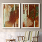 Set of two white barnwood framed canvas prints depicting two earthy modern abstracts featuring rust orange black cream and green brush bands above a sideboard in a cozy sitting room.