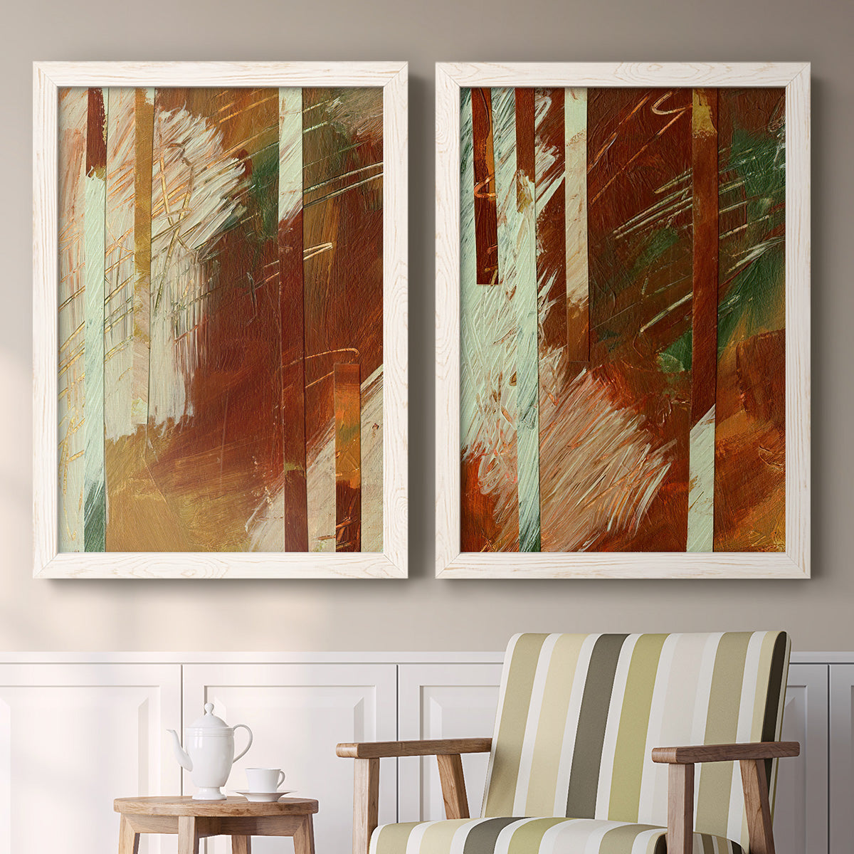 Set of two white barnwood framed canvas prints depicting two earthy modern abstracts featuring rust orange black cream and green brush bands above a sideboard in a cozy sitting room.