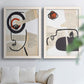 Set of two white barnwood framed canvas prints depicting black contour features, red blocks, typography, and torn-paper textures arranged across two complementary compositions above a sofa in a bright living space.