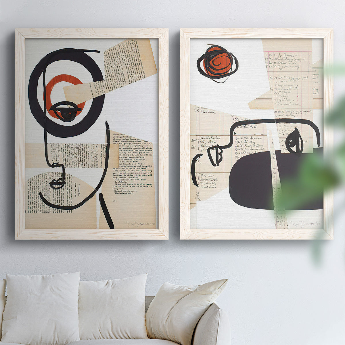 Set of two white barnwood framed canvas prints depicting black contour features, red blocks, typography, and torn-paper textures arranged across two complementary compositions above a sofa in a bright living space.