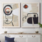 Set of two white barnwood framed canvas prints depicting a coordinated art pair of cubist faces layered over vintage book pages rendered as mixed-media portrait collages above a dining room sideboard.