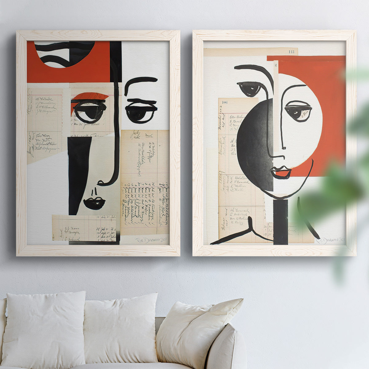 Set of two white barnwood framed canvas prints depicting black contour features, red blocks, typography, and torn-paper textures arranged across two complementary compositions above a sofa in a bright living space.