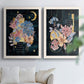 Set of two white barnwood framed canvas prints depicting moons stars hanging jewels colorful blossoms and hand-lettered phrases arranged across two complementary compositions above a sofa in a bright living space.