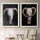 Set of two white barnwood framed canvas prints depicting two dramatic Western animal paintings featuring ram and cattle skulls against black grounds above a sideboard in a cozy sitting room.