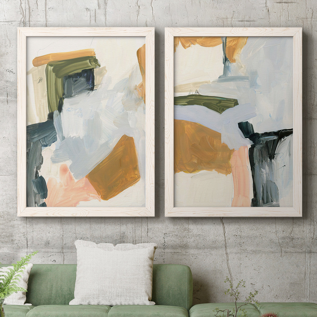 Set of two white barnwood framed canvas prints depicting a coordinated art pair of layered green ochre blush gray and white paint blocks rendered as contemporary mixed-media abstracts above a sofa in a modern living room.