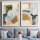 Set of two white barnwood framed canvas prints depicting paired contemporary mixed-media abstracts with broad geometric marks, soft overlaps, and restrained warm accents above a sofa in a contemporary living room.