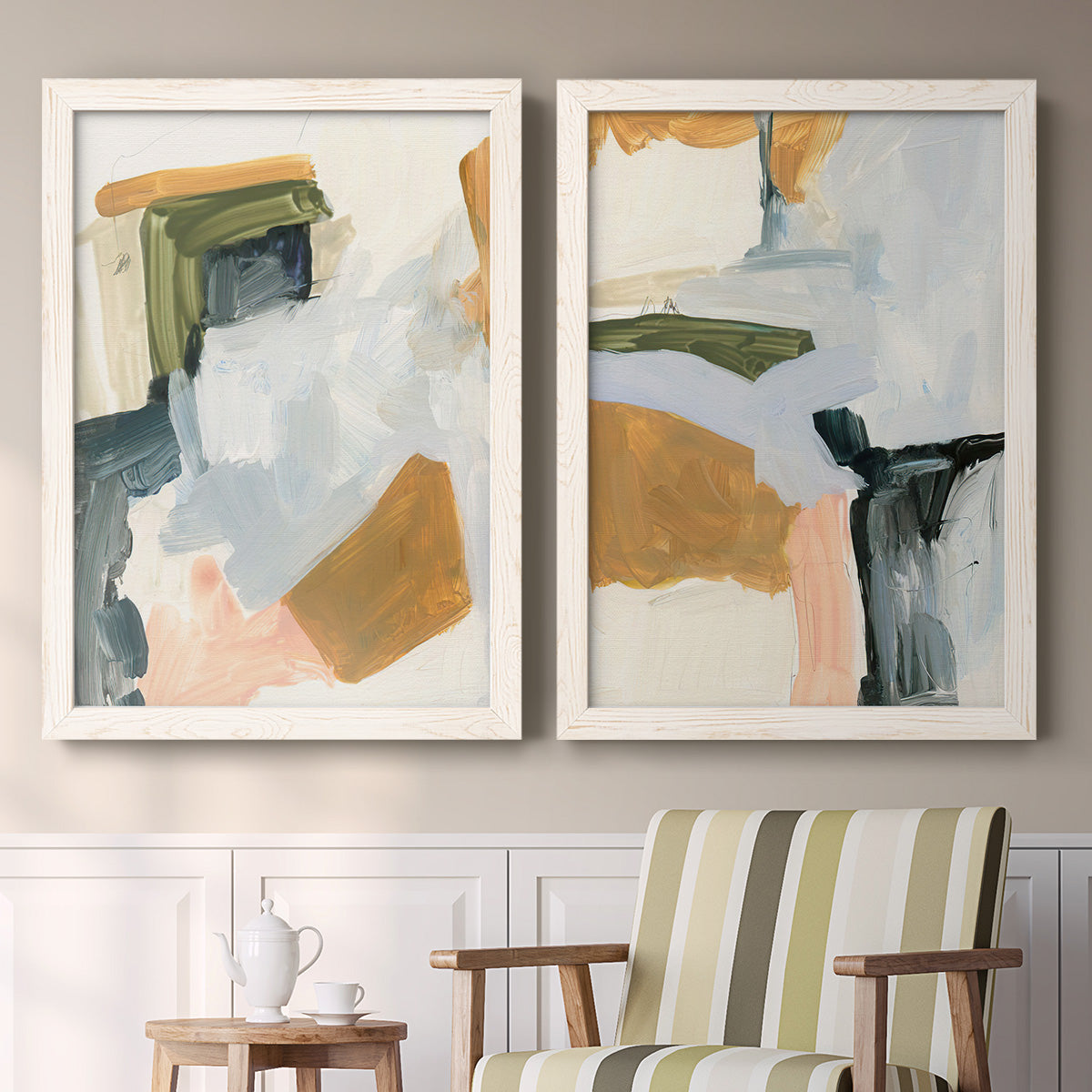 Set of two white barnwood framed canvas prints depicting two contemporary mixed-media abstracts featuring layered green ochre blush gray and white paint blocks above a sideboard in a cozy sitting room.