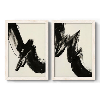 Set of two white barnwood framed canvas prints featuring two bold gestural abstracts featuring sweeping black calligraphic brushstrokes.