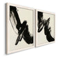 Angled view of a set of two white barnwood framed canvas prints featuring two bold gestural abstracts featuring sweeping black calligraphic brushstrokes.