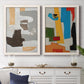 Set of two white barnwood framed canvas prints depicting a coordinated art pair of stacked gray cream blue and bright geometric blocks rendered as mid-century geometric abstracts above a dining room sideboard.