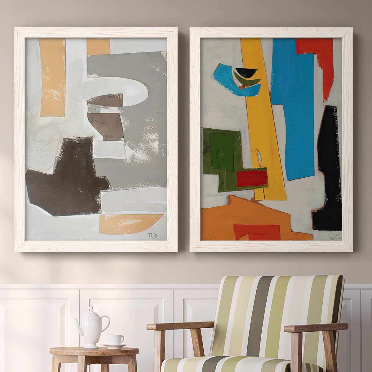 Set of two white barnwood framed canvas prints depicting two mid-century geometric abstracts featuring stacked gray cream blue and bright geometric blocks above a sideboard in a cozy sitting room.