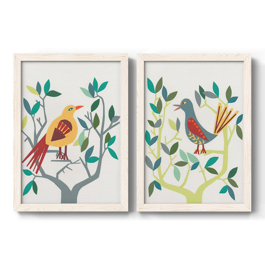 Set of two white barnwood framed canvas prints featuring two modern folk-art bird illustrations featuring stylized colorful birds perched among leafy branches.