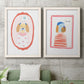 Set of two white barnwood framed canvas prints depicting a coordinated art pair of playful framed portraits of fashionable cats and dogs rendered as whimsical nursery illustrations above a sofa in a modern living room.