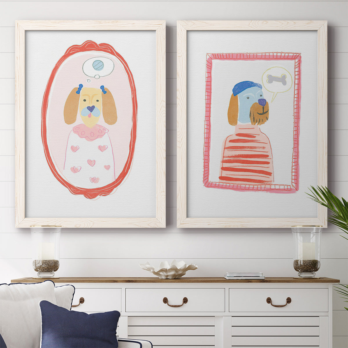 Set of two white barnwood framed canvas prints depicting a coordinated art pair of playful framed portraits of fashionable cats and dogs rendered as whimsical nursery illustrations above a dining room sideboard.