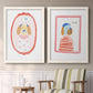 Set of two white barnwood framed canvas prints depicting two whimsical nursery illustrations featuring playful framed portraits of fashionable cats and dogs above a sideboard in a cozy sitting room.