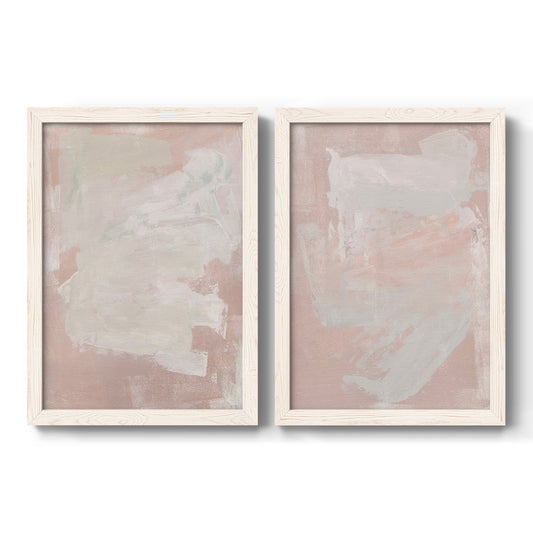 Set of two white barnwood framed canvas prints featuring two minimalist color-field abstracts featuring soft blush and white painterly fields.