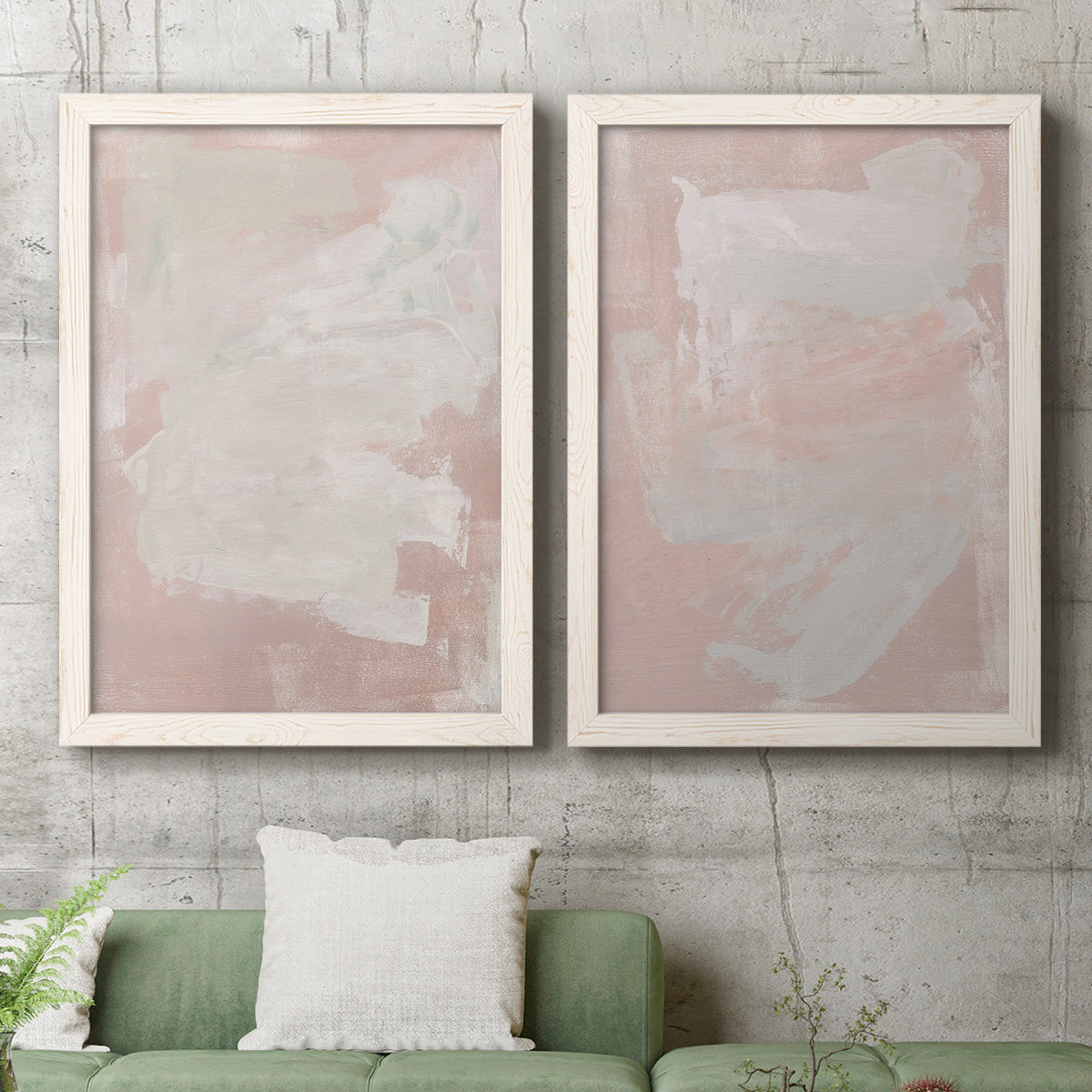Set of two white barnwood framed canvas prints depicting a coordinated art pair of soft blush and white painterly fields rendered as minimalist color-field abstracts above a sofa in a modern living room.