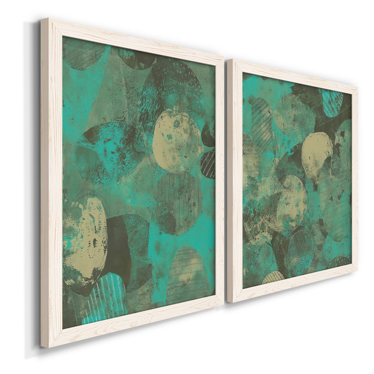 Angled view of a set of two white barnwood framed canvas prints featuring two textured organic abstracts featuring layered mint teal and beige circular forms.