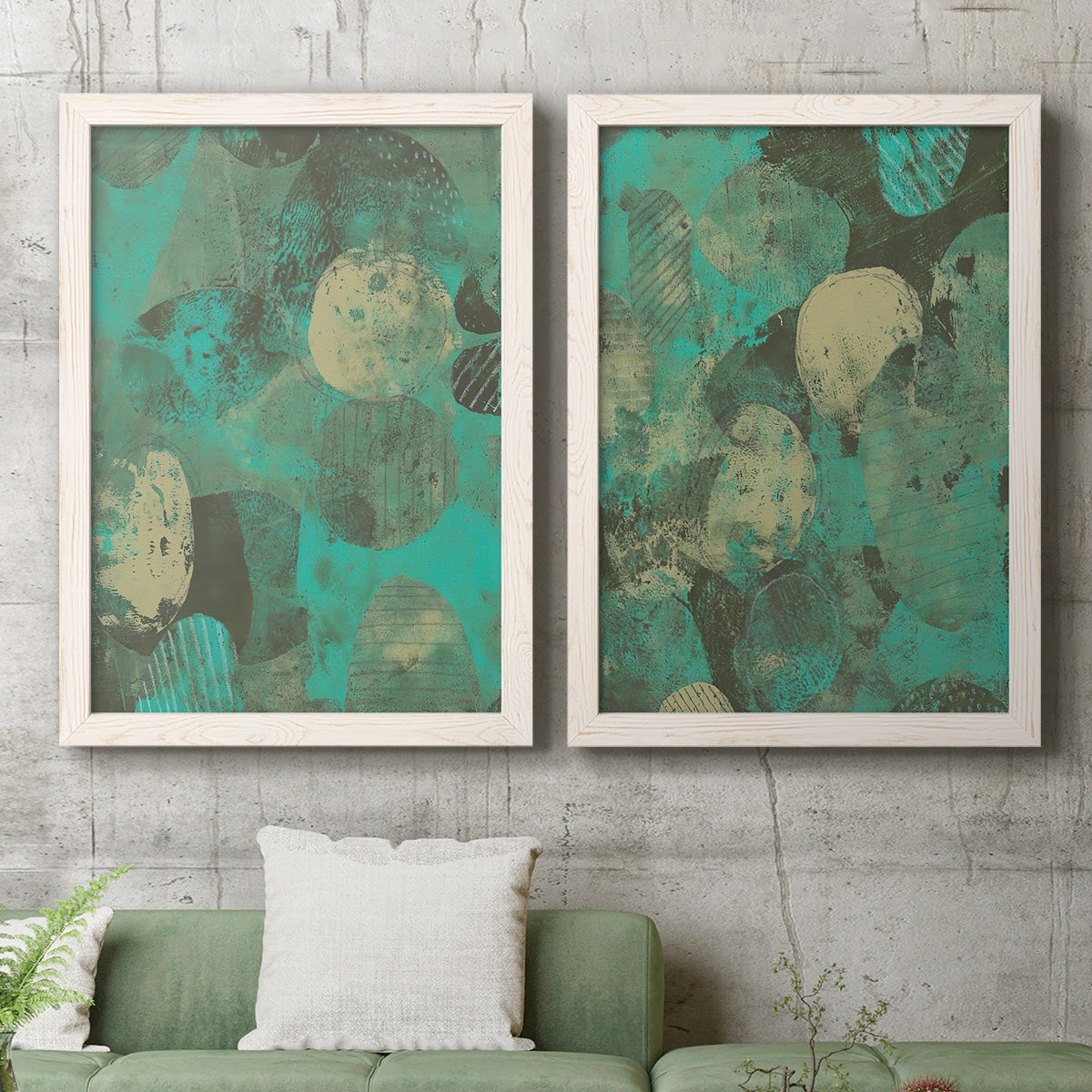 Set of two white barnwood framed canvas prints depicting a coordinated art pair of layered mint teal and beige circular forms rendered as textured organic abstracts above a sofa in a modern living room.