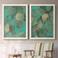 Set of two white barnwood framed canvas prints depicting two textured organic abstracts featuring layered mint teal and beige circular forms above a sideboard in a cozy sitting room.