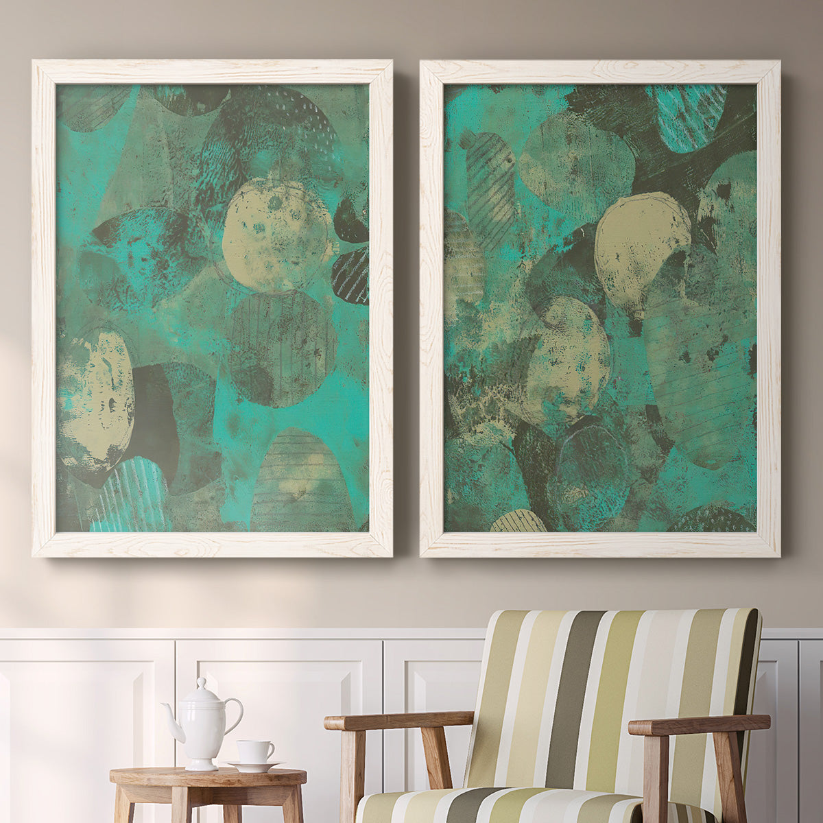 Set of two white barnwood framed canvas prints depicting two textured organic abstracts featuring layered mint teal and beige circular forms above a sideboard in a cozy sitting room.