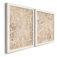 Angled view of a set of two white barnwood framed canvas prints featuring two vintage decorative prints featuring ornate cream floral damask patterns.