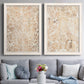 Set of two white barnwood framed canvas prints depicting paired vintage decorative prints with dense scrolling foliage, distressed walnut-brown texture, and symmetrical motifs above a sofa in a contemporary living room.