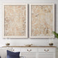 Set of two white barnwood framed canvas prints depicting a coordinated art pair of ornate cream floral damask patterns rendered as vintage decorative prints above a dining room sideboard.