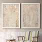 Set of two white barnwood framed canvas prints depicting two vintage decorative prints featuring ornate cream floral damask patterns above a sideboard in a cozy sitting room.