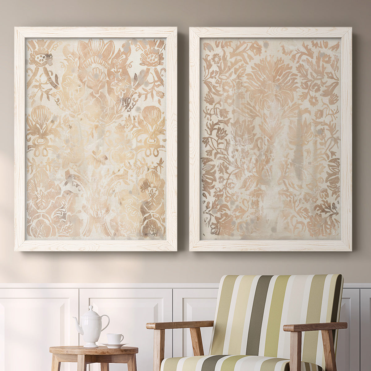 Set of two white barnwood framed canvas prints depicting two vintage decorative prints featuring ornate cream floral damask patterns above a sideboard in a cozy sitting room.