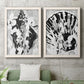Set of two white barnwood framed canvas prints depicting a coordinated art pair of black and gray inkblot bursts rendered as dramatic monochrome abstracts above a sofa in a modern living room.