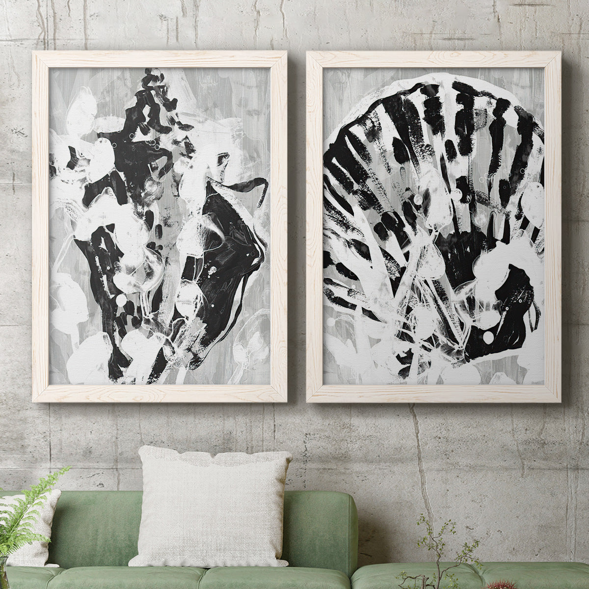 Set of two white barnwood framed canvas prints depicting a coordinated art pair of black and gray inkblot bursts rendered as dramatic monochrome abstracts above a sofa in a modern living room.