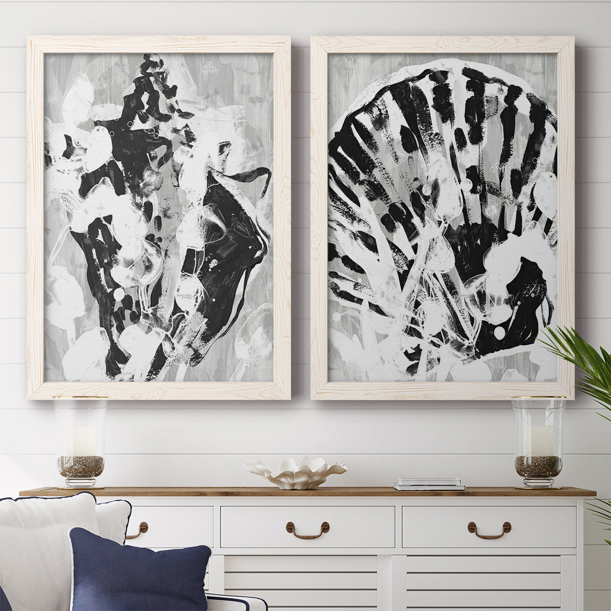 Set of two white barnwood framed canvas prints depicting a coordinated art pair of black and gray inkblot bursts rendered as dramatic monochrome abstracts above a dining room sideboard.