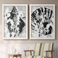 Set of two white barnwood framed canvas prints depicting two dramatic monochrome abstracts featuring black and gray inkblot bursts above a sideboard in a cozy sitting room.